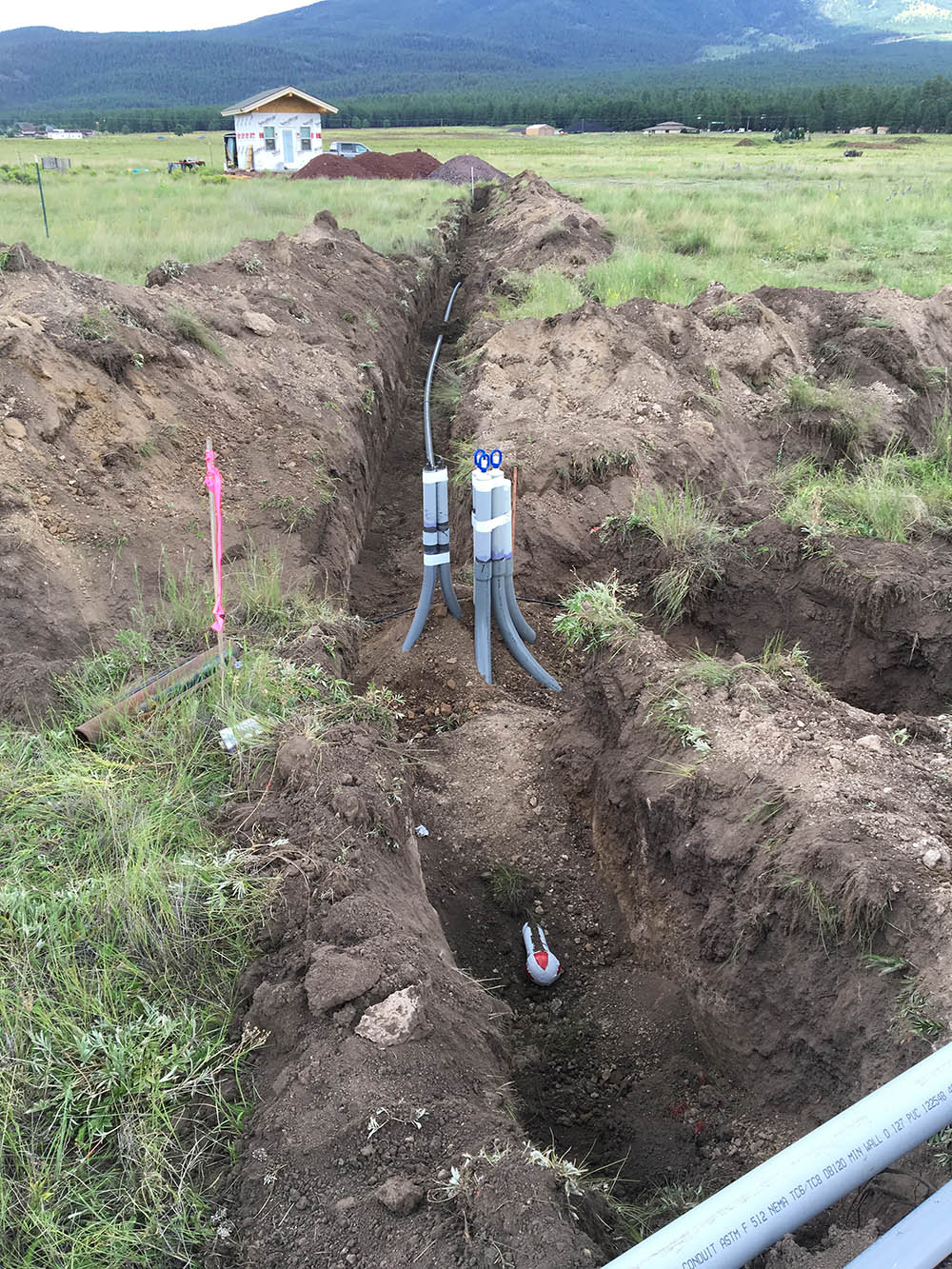 Installing underground electrical lines to a new house in Baderville, near AZ Snowbowl